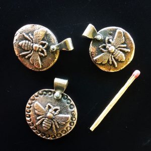 Sand-cast bronze bee pendants with silver rivet